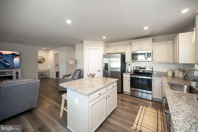 a large kitchen with a table and chairs in it