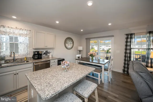 a dining room with furniture and wooden floor