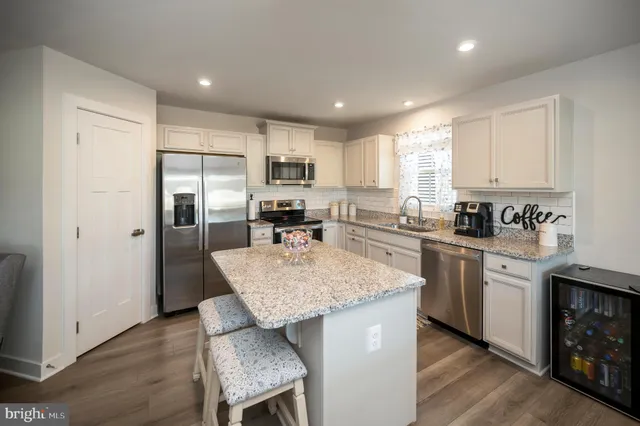 a view of a hallway with wooden floor and closet