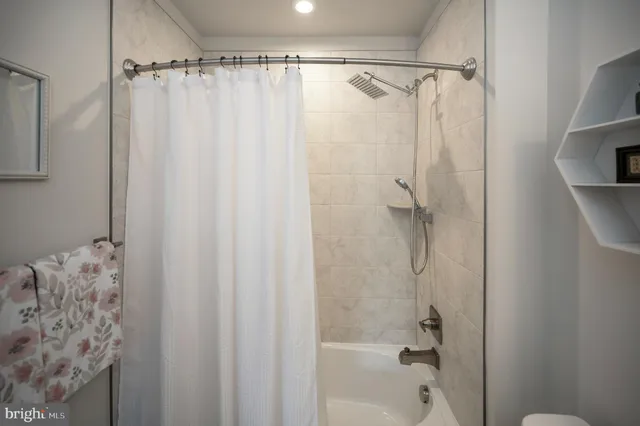 a living room with furniture a flat screen tv and a wooden floor