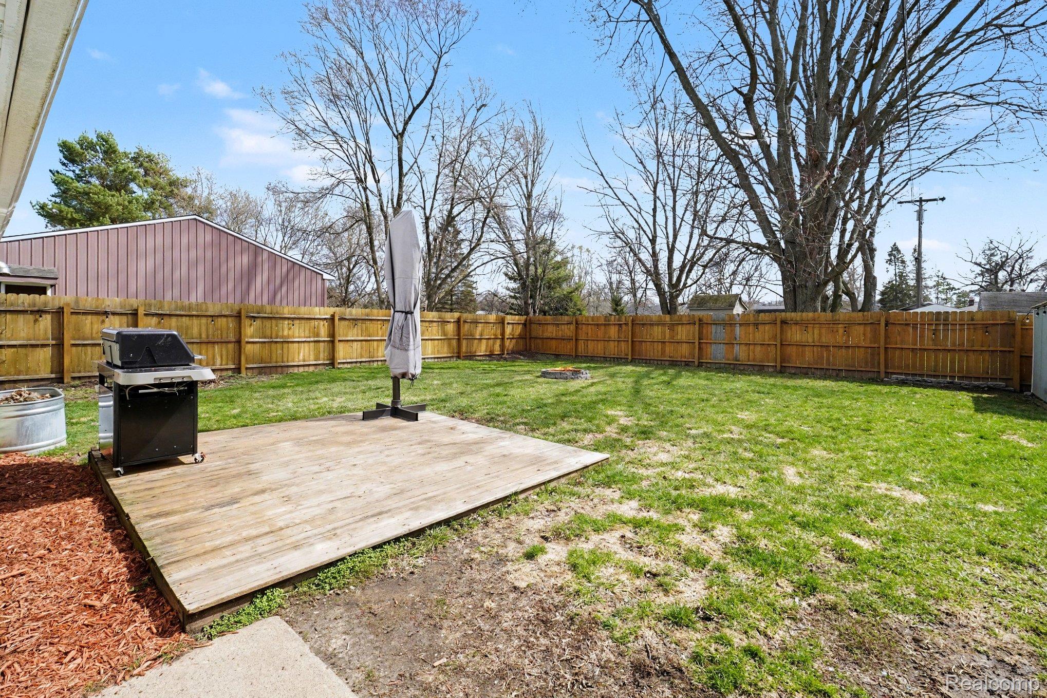 16485 Jennings Road Fenton, MI 48430 - Photo 8 of 27 Fenced backyard featuring a wooden deck