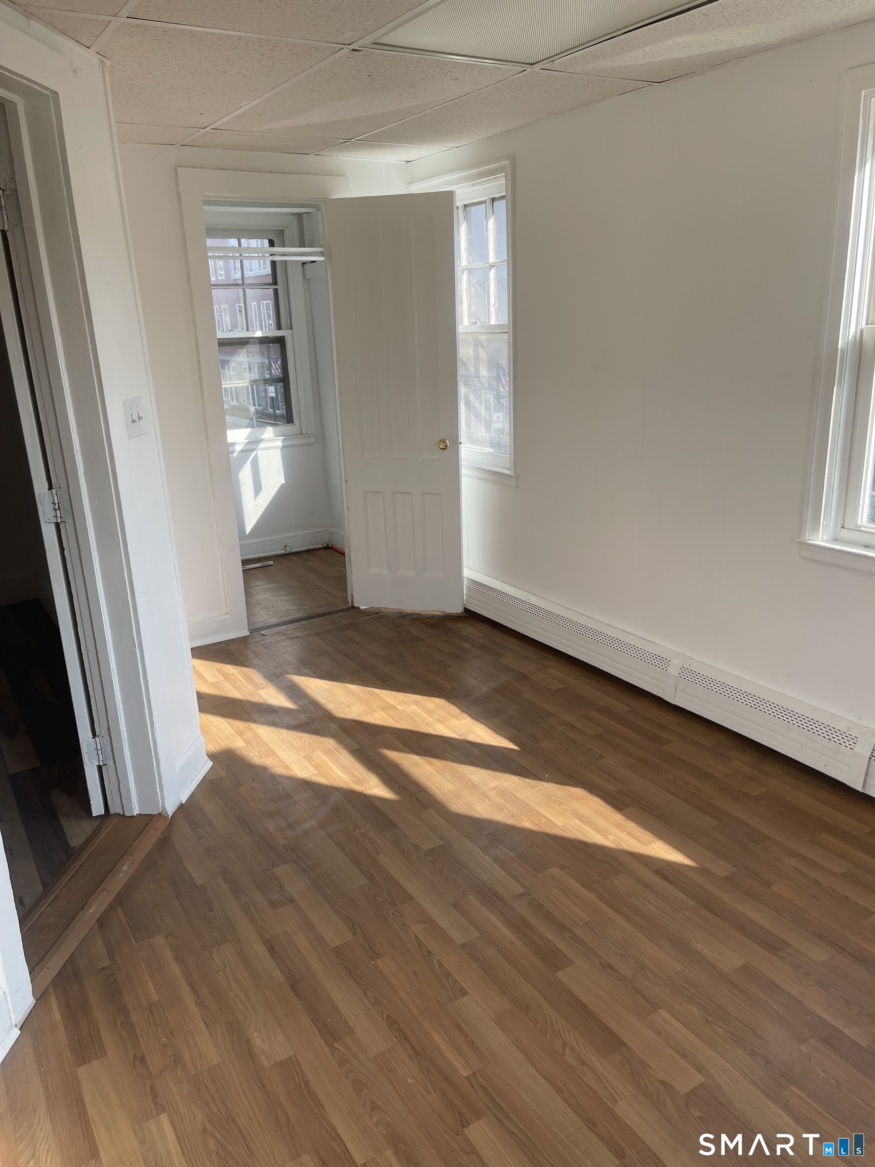 85 Franklin Street Torrington, CT 06790 - Photo 13 of 21 an empty room with wooden floor and windows