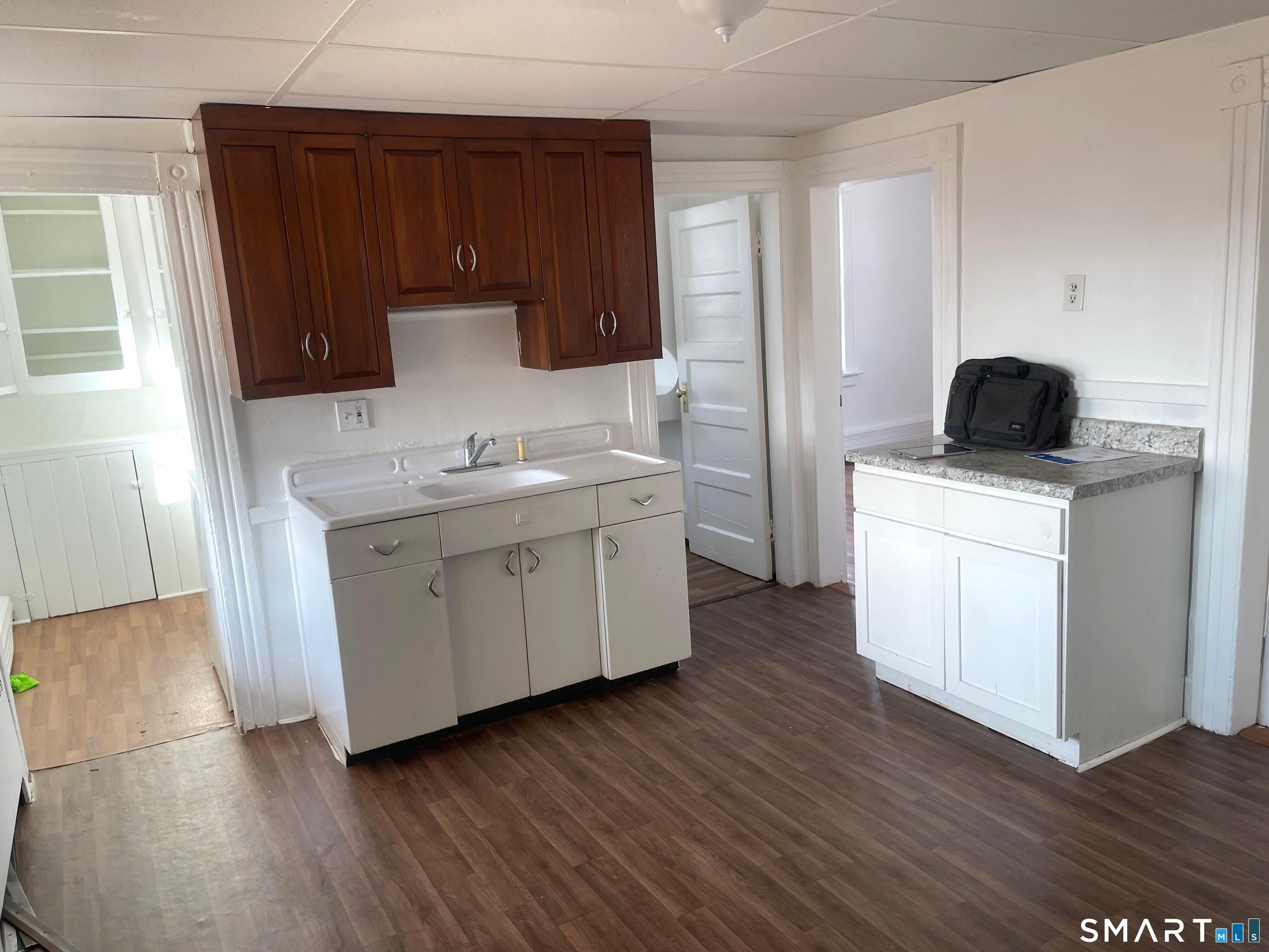 85 Franklin Street Torrington, CT 06790 - Photo 4 of 21 a kitchen with a sink a stove and cabinets