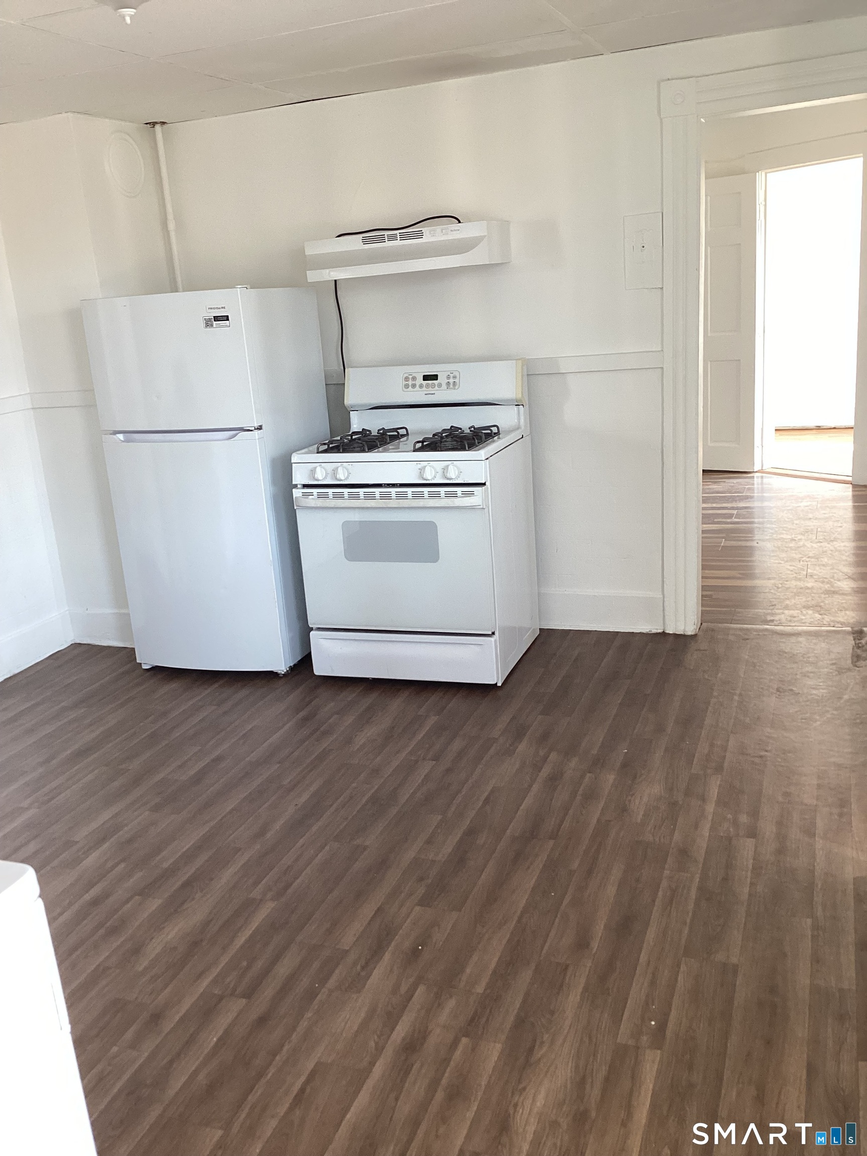 85 Franklin Street Torrington, CT 06790 - Photo 5 of 21 a view of a kitchen with wooden floor and white stainless steel appliances