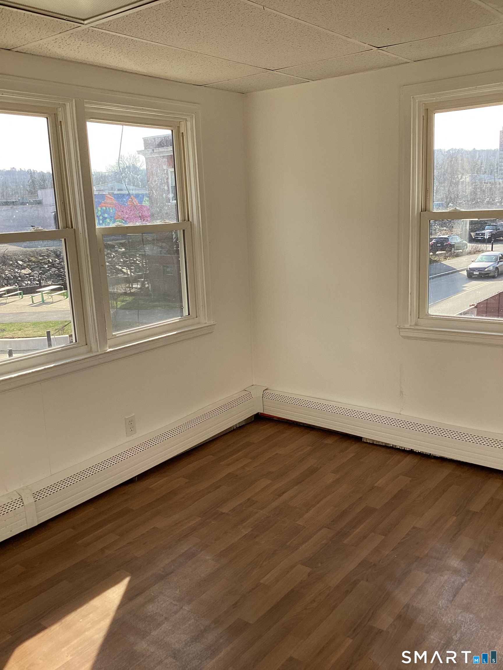 85 Franklin Street Torrington, CT 06790 - Photo 9 of 21 a view of an empty room with wooden floor and a window