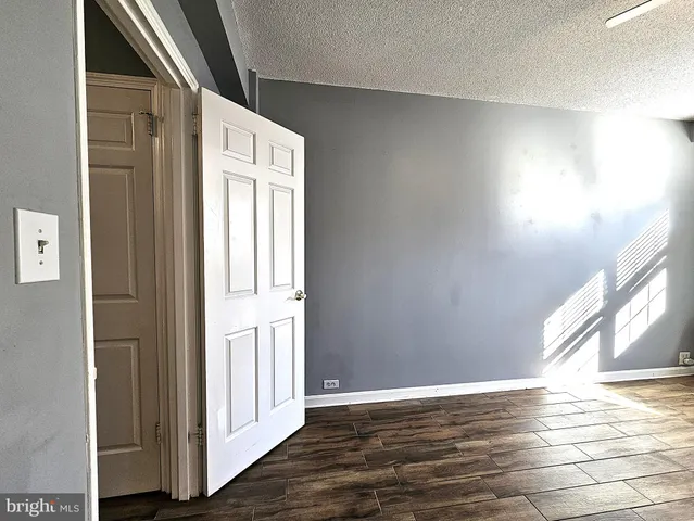 a view of an empty room and wooden floor