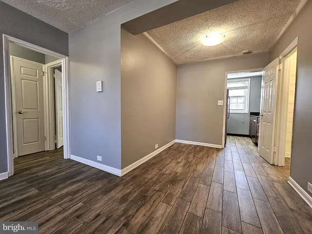 a view of hallway with wooden floor