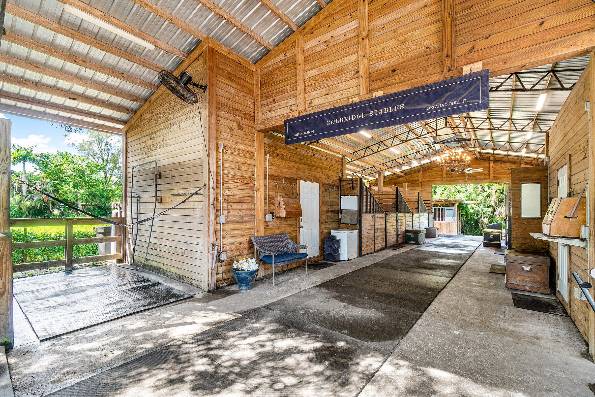 3479 D Road Loxahatchee Groves, FL 33470 - Photo 3 of 12 a view of a patio with a table and chairs next to a yard