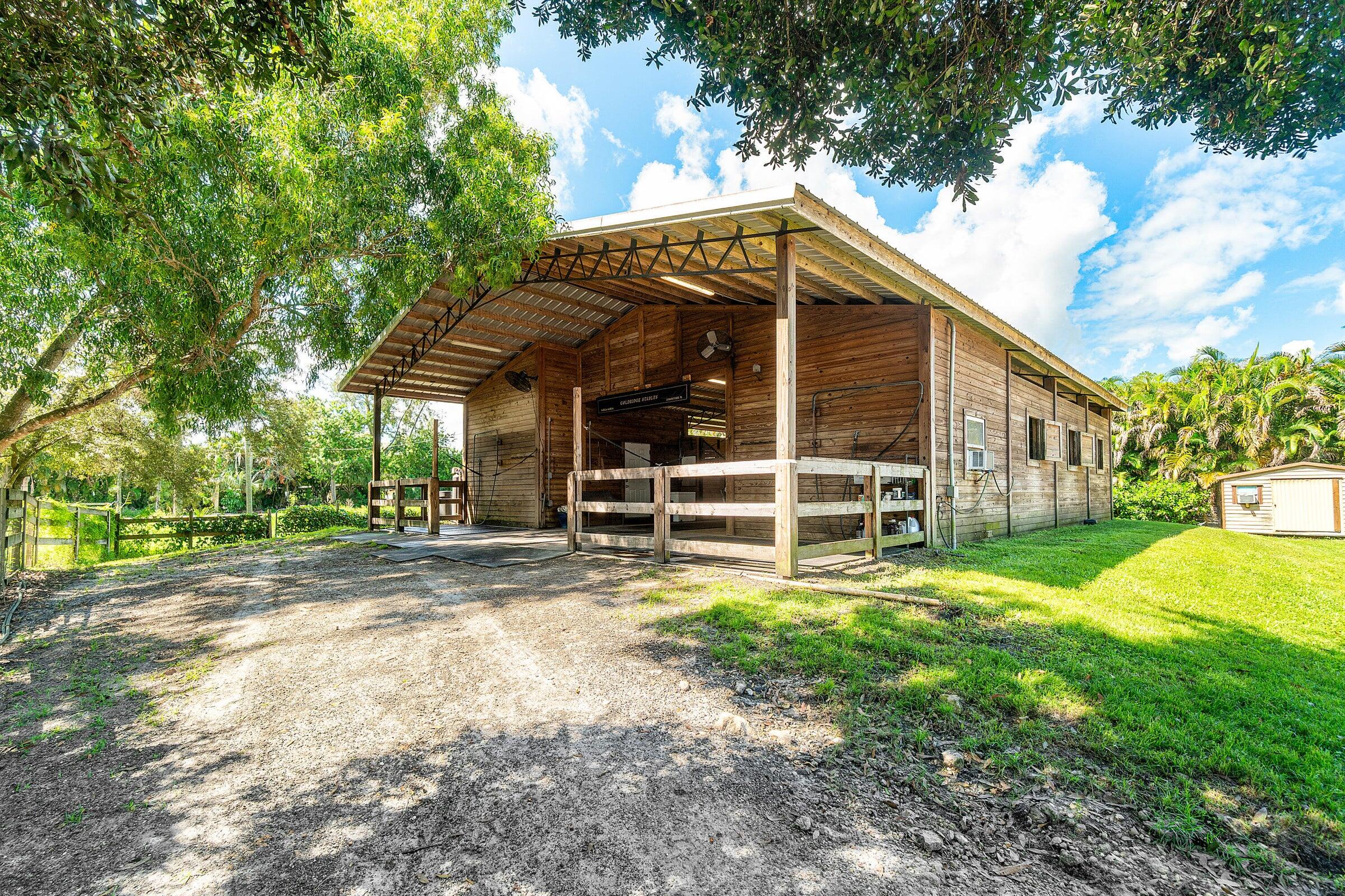 3479 D Road Loxahatchee Groves, FL 33470 - Photo 6 of 12 a view of a house with backyard and sitting area