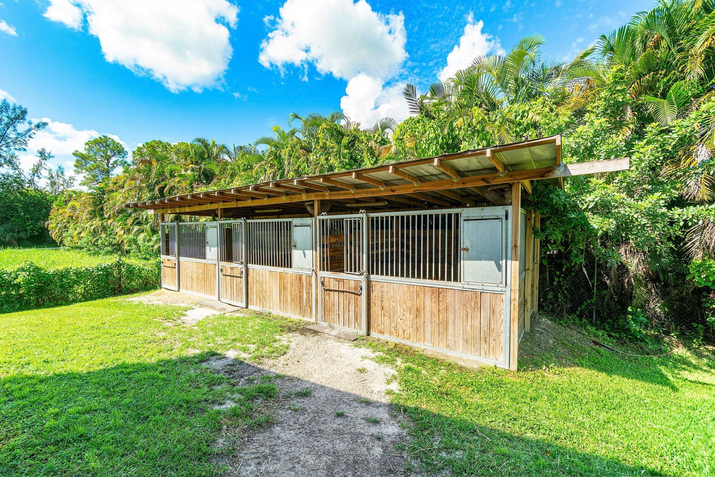3479 D Road Loxahatchee Groves, FL 33470 - Photo 8 of 12 a view of a house with a yard