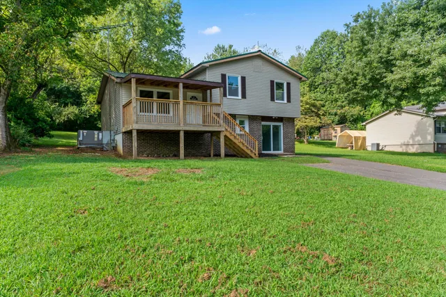 a view of a house with a yard and sitting area
