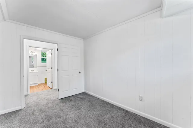a bathroom with a toilet sink vanity and mirror