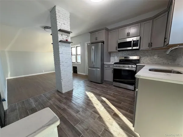 a kitchen with stainless steel appliances granite countertop a refrigerator stove microwave and sink