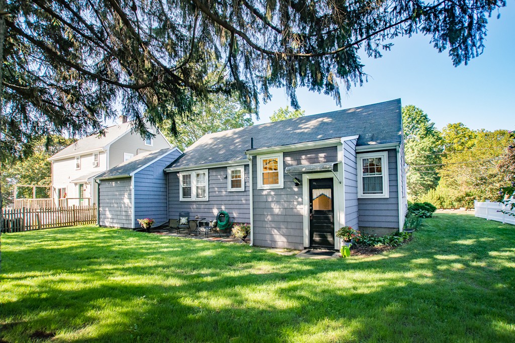 24 Murray Road Newton, MA 02465 - Photo 23 of 30 a brick house with a big yard plants and large trees