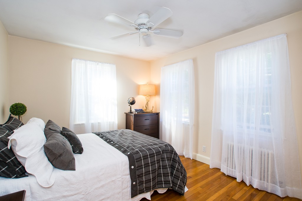 24 Murray Road Newton, MA 02465 - Photo 4 of 30 a bedroom with a bed and a chandelier