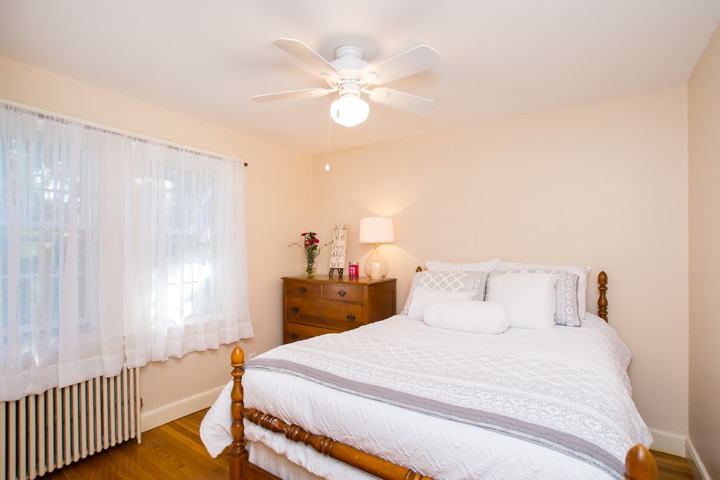 24 Murray Road Newton, MA 02465 - Photo 8 of 30 a bedroom with a bed and a chandelier