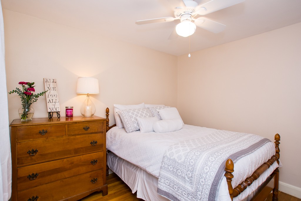 24 Murray Road Newton, MA 02465 - Photo 9 of 30 a bedroom with a bed and a chandelier