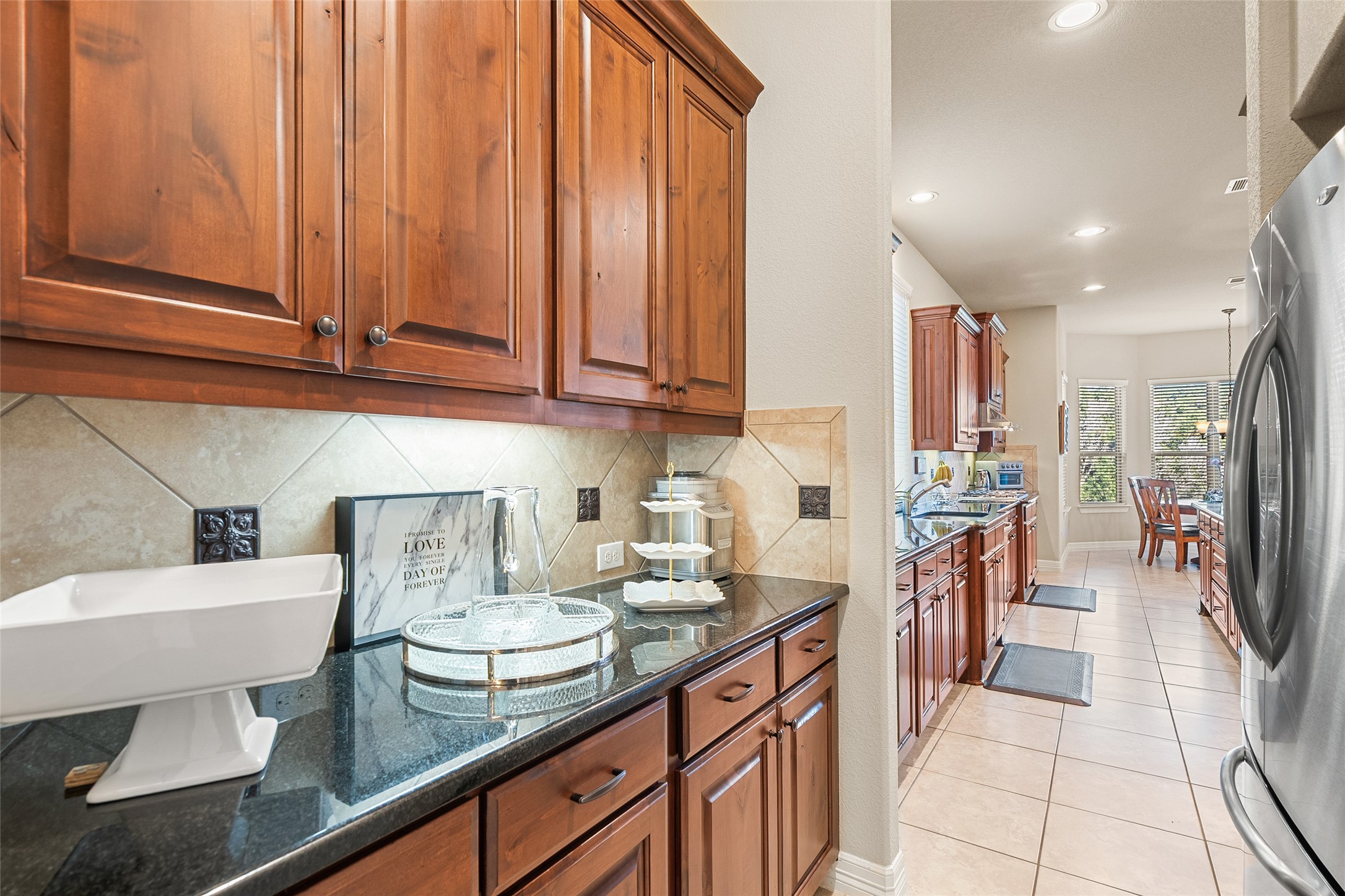 1200 Lions Lair Leander, TX 78641 - Photo 16 of 40 a kitchen with stainless steel appliances kitchen island granite countertop a sink and cabinets