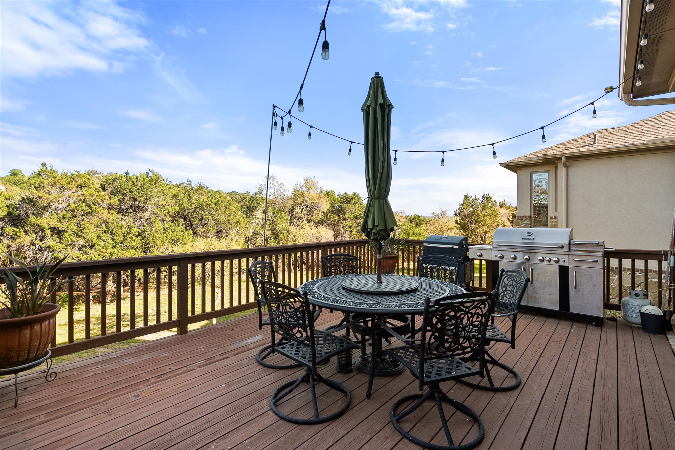 1200 Lions Lair Leander, TX 78641 - Photo 31 of 40 a view of a balcony dining area with furniture wooden floor kitchen and a chandelier