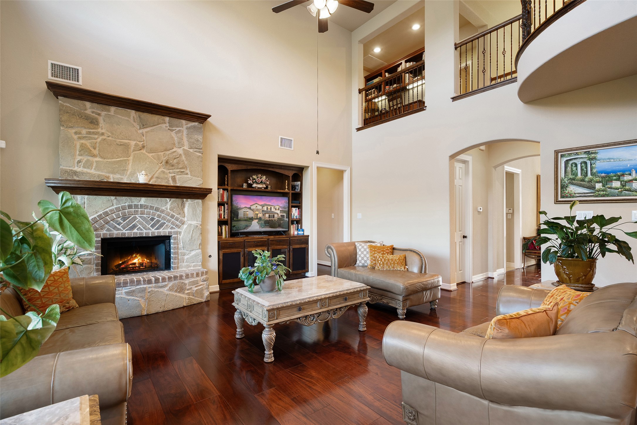 1200 Lions Lair Leander, TX 78641 - Photo 9 of 40 a living room with furniture a fireplace and a flat screen tv