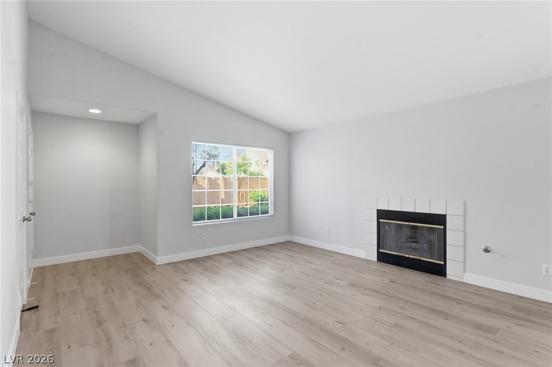 5449 Bugle Way, Unit 104 Las Vegas, NV 89108 - Photo 14 of 33 This airy living space features a cozy fireplace and abundant natural light.