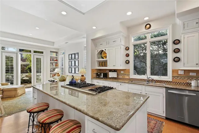 a kitchen with granite countertop lots of counter top space and windows