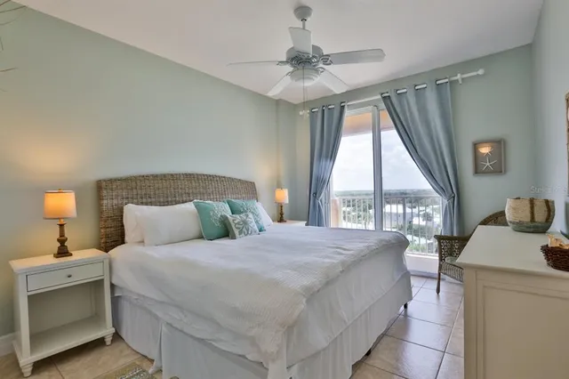 a bedroom with a large bed and a chandelier