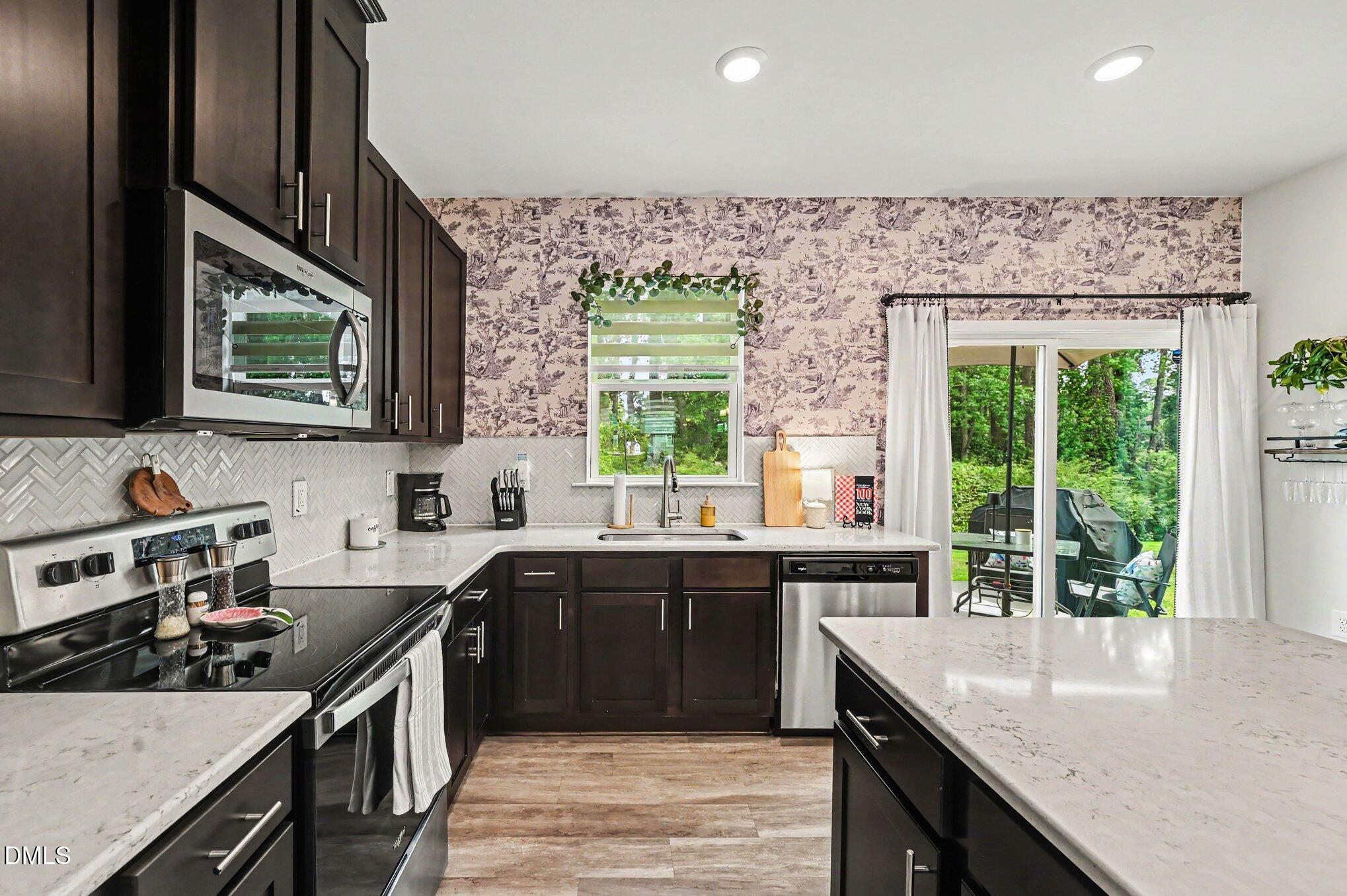 574 Hacksaw Trail Raleigh, NC 27610 - Photo 3 of 28 a kitchen with a sink stove and microwave