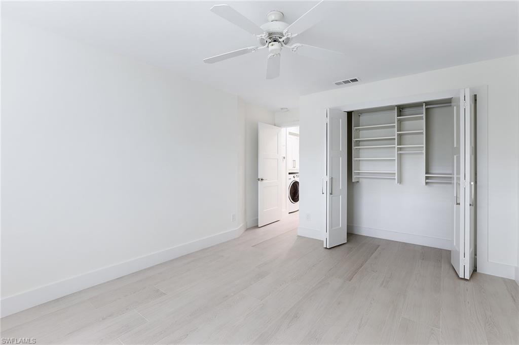116 Fountain Circle Naples, FL 34119 - Photo 18 of 24 an empty room with a empty space and windows