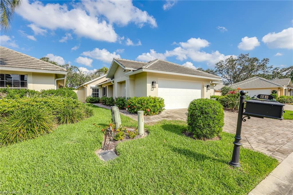 116 Fountain Circle Naples, FL 34119 - Photo 2 of 24 a view of a yard in front of house