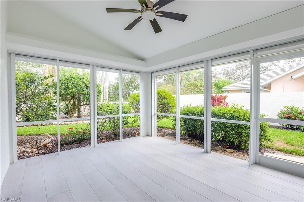 116 Fountain Circle Naples, FL 34119 - Photo 22 of 24 a view of a deck hardwood flooring and trees in a room