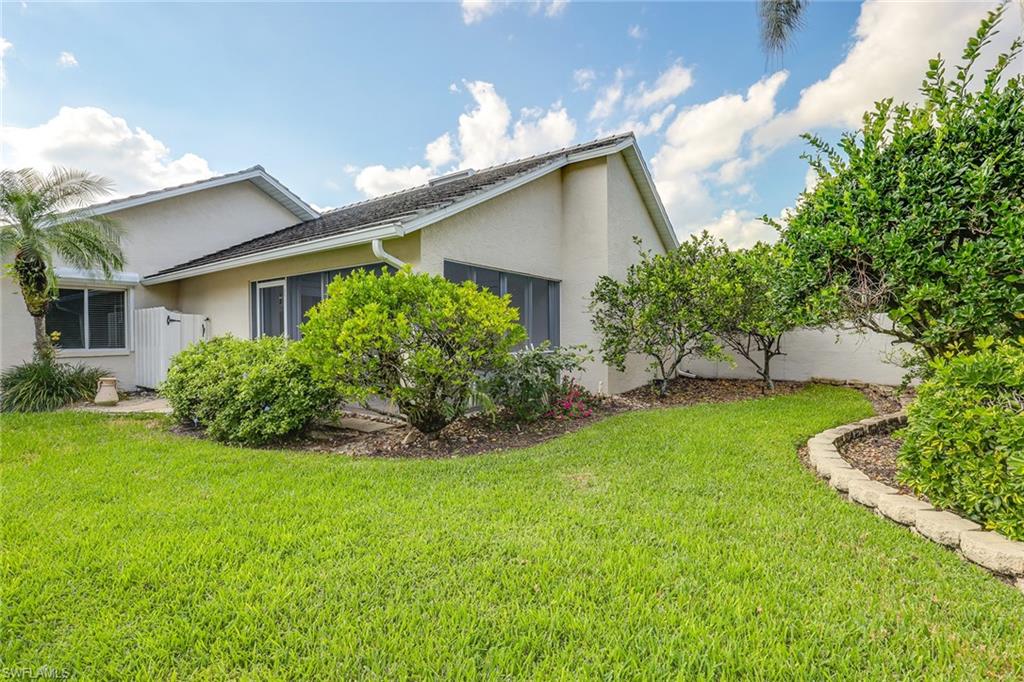 116 Fountain Circle Naples, FL 34119 - Photo 24 of 24 a view of a house with a back yard