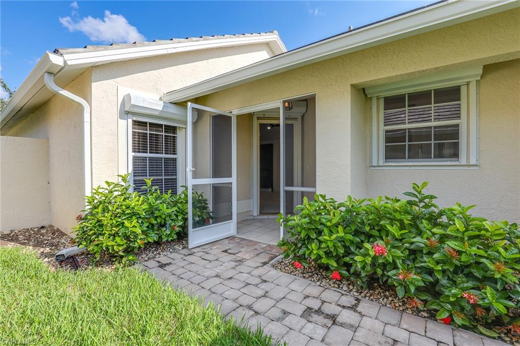 116 Fountain Circle Naples, FL 34119 - Photo 4 of 24 front view of a house