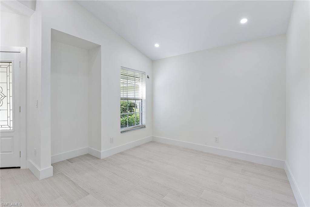 116 Fountain Circle Naples, FL 34119 - Photo 6 of 24 an empty room with windows