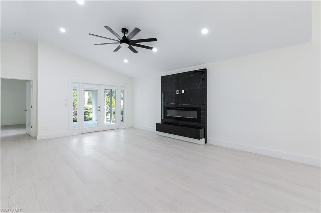 116 Fountain Circle Naples, FL 34119 - Photo 7 of 24 an empty room with windows and ceiling fan