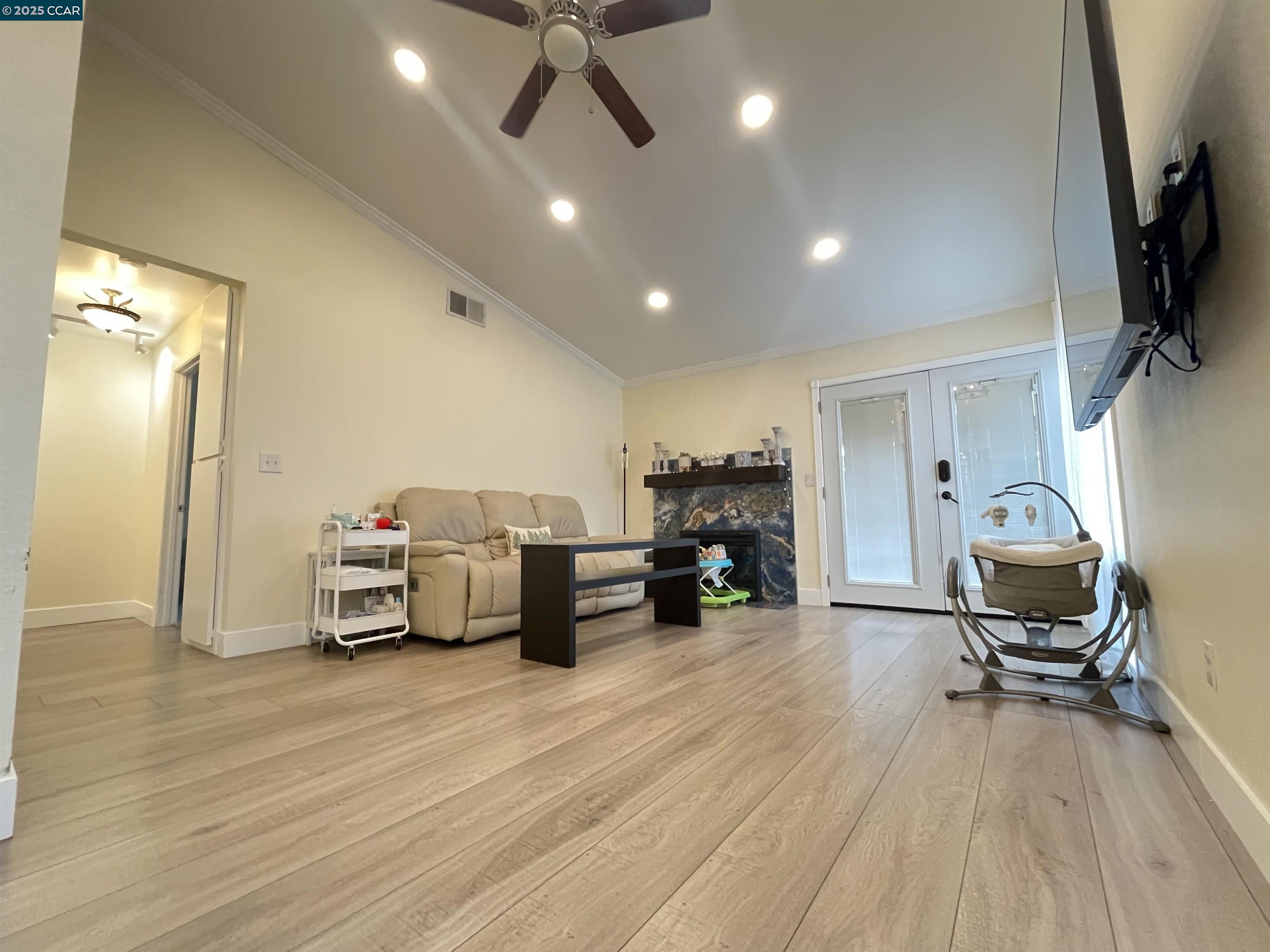 a living room with furniture and a flat screen tv