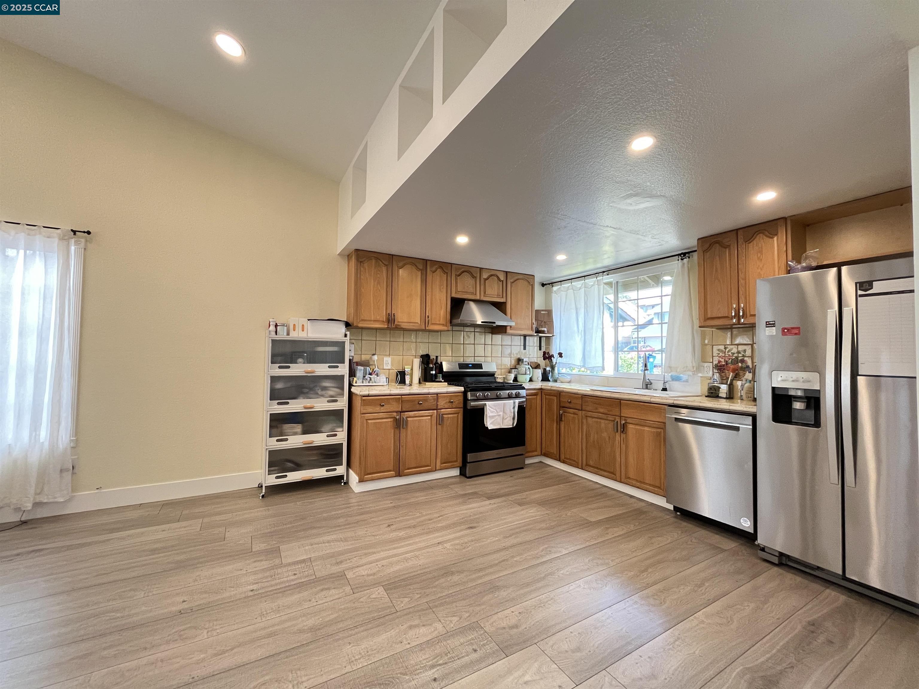 120 Bonita Court Rodeo, CA 94572 - Photo 11 of 49 a kitchen with stainless steel appliances and refrigerator