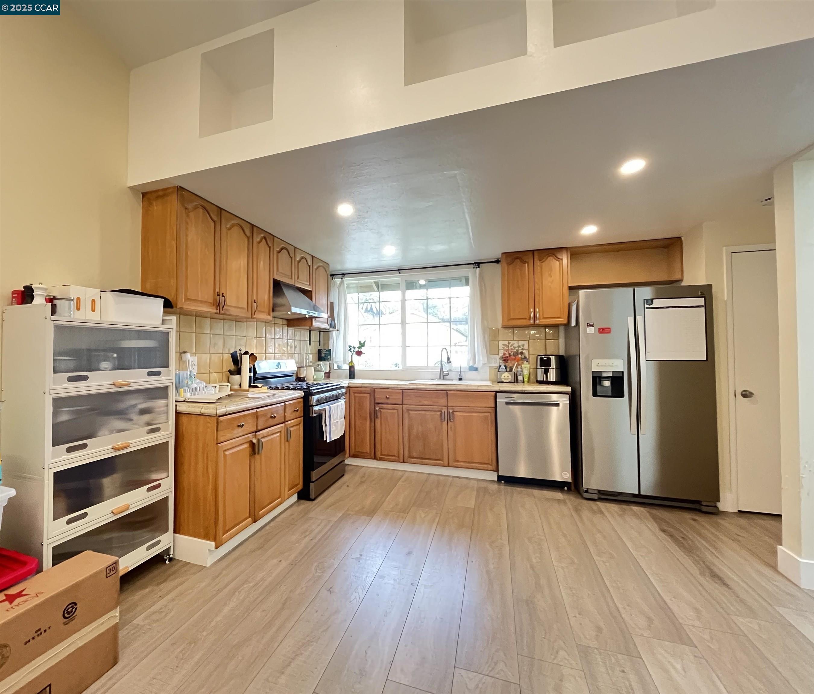 120 Bonita Court Rodeo, CA 94572 - Photo 13 of 49 a kitchen with stainless steel appliances a refrigerator and a stove top oven