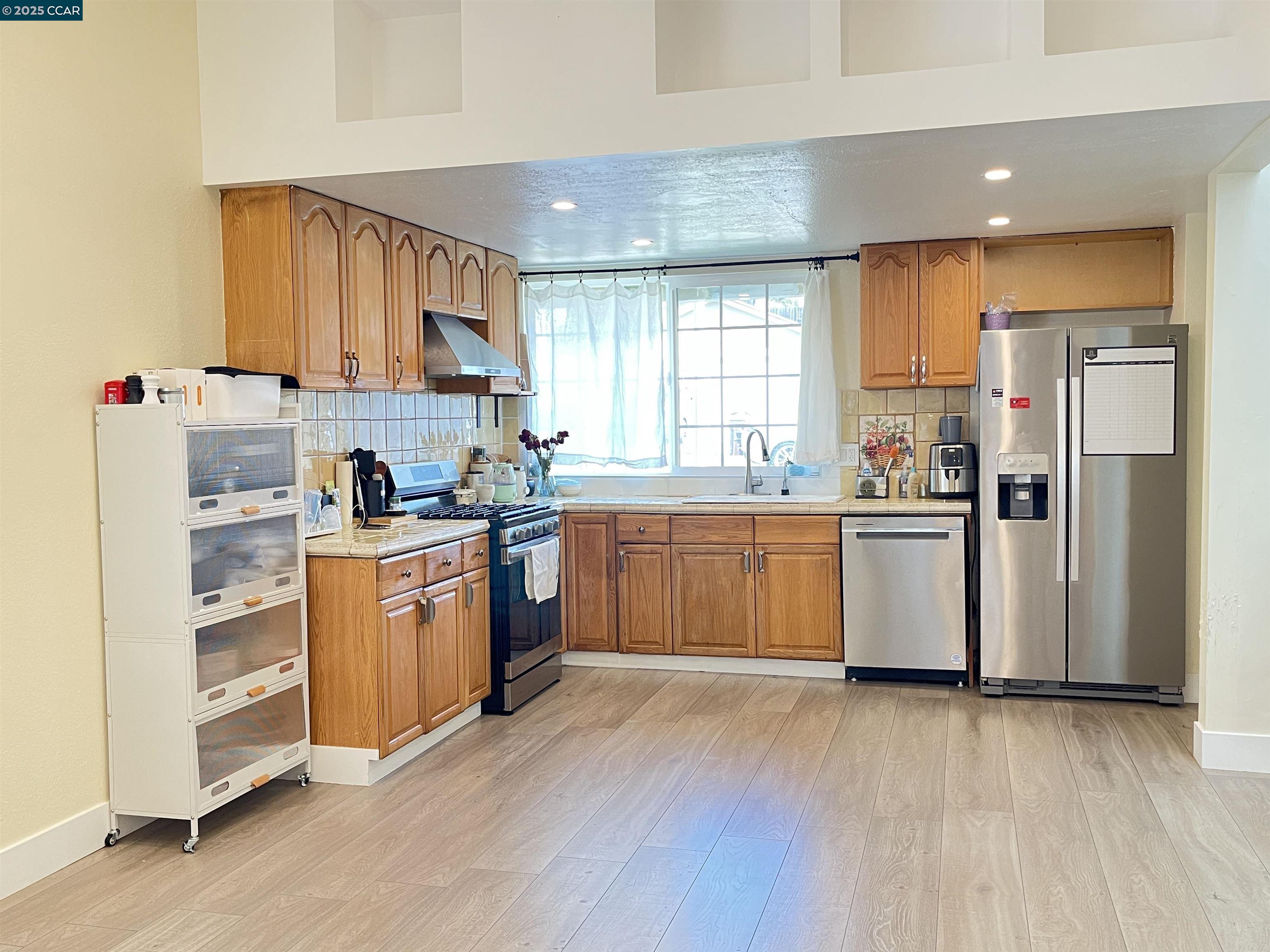 120 Bonita Court Rodeo, CA 94572 - Photo 14 of 49 a kitchen with a sink refrigerator and cabinets