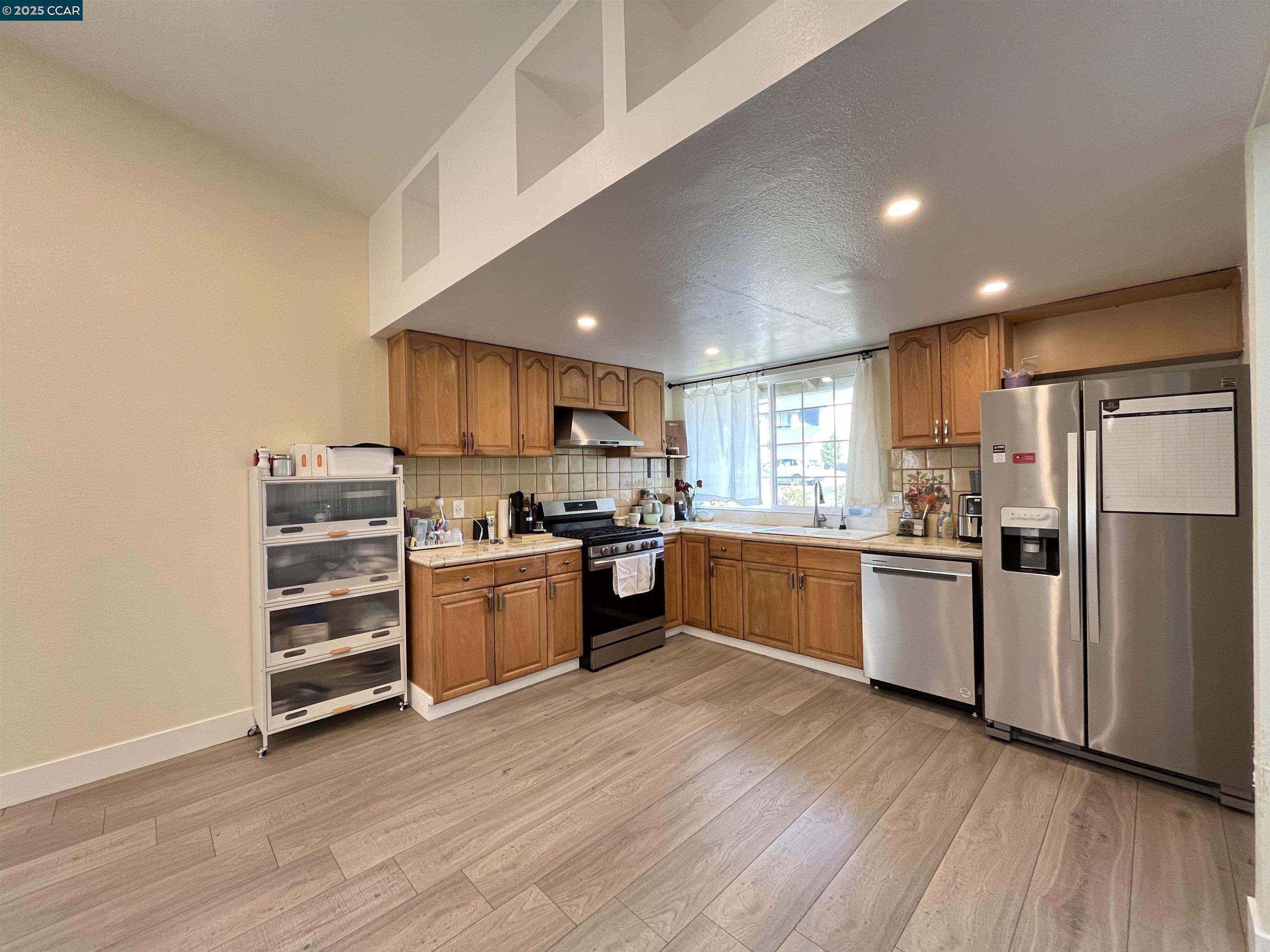120 Bonita Court Rodeo, CA 94572 - Photo 15 of 49 a kitchen with a refrigerator and white cabinets