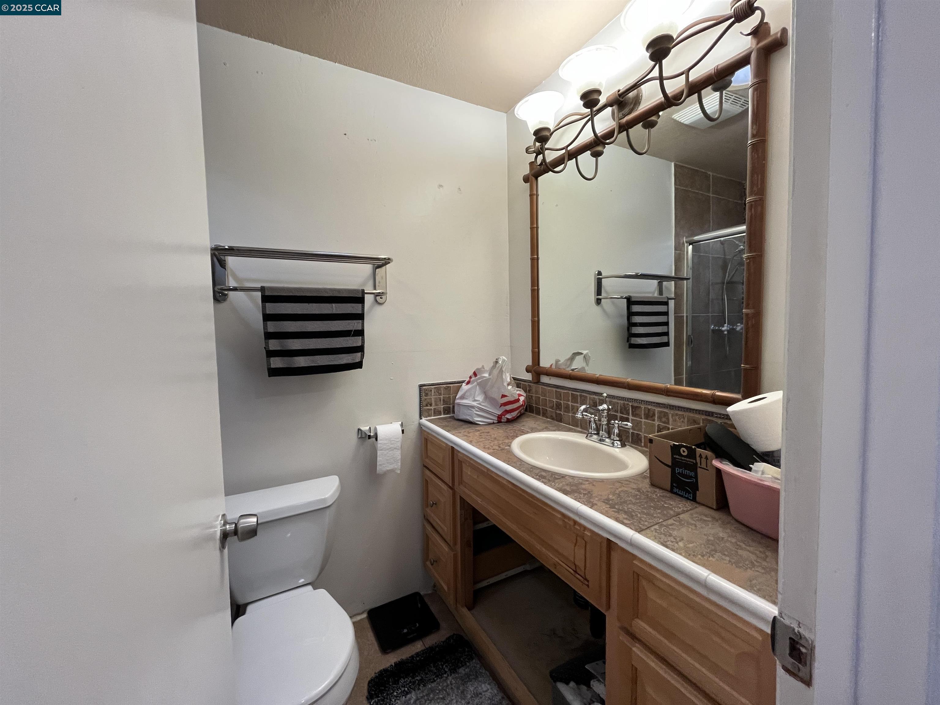 120 Bonita Court Rodeo, CA 94572 - Photo 25 of 49 a bathroom with a granite countertop toilet sink and mirror