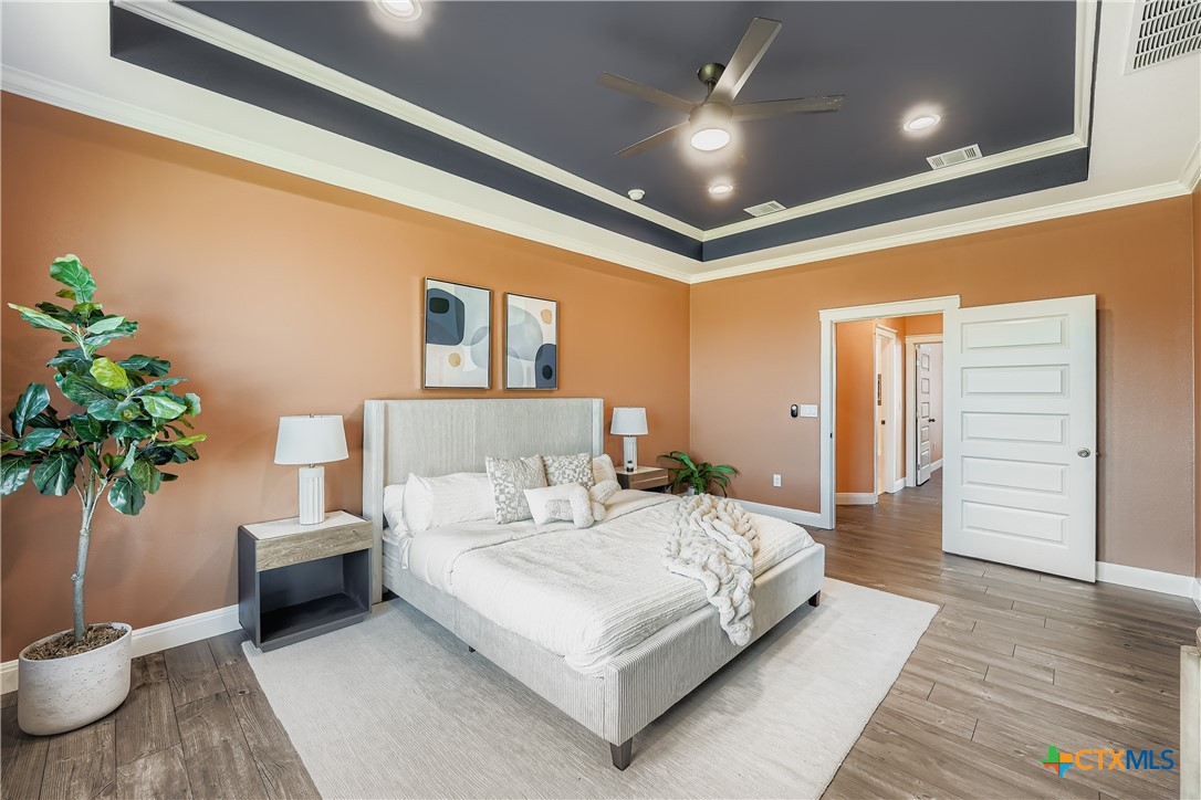 222 Arosa Drive Elgin, TX 78621 - Photo 8 of 40 a bedroom with a large bed and a potted plant