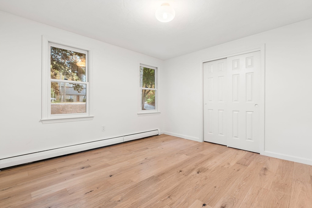 34 Saddleback Road Mashpee, MA 02649 - Photo 11 of 24 an empty room with wooden floor and windows