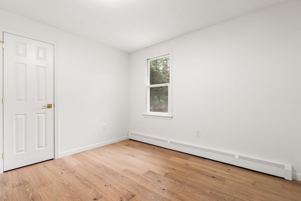 34 Saddleback Road Mashpee, MA 02649 - Photo 12 of 24 an empty room with wooden floor and windows