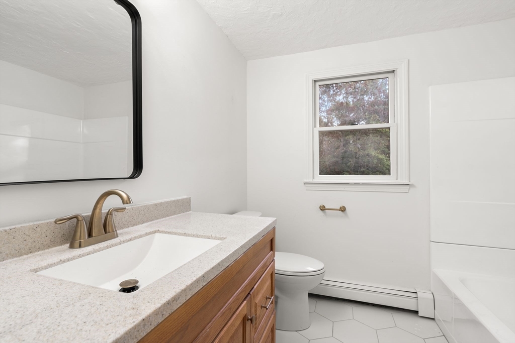 34 Saddleback Road Mashpee, MA 02649 - Photo 17 of 24 a bathroom with a toilet sink and mirror