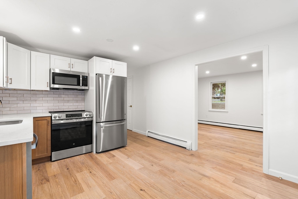 34 Saddleback Road Mashpee, MA 02649 - Photo 3 of 24 a kitchen with a stove a refrigerator and a microwave
