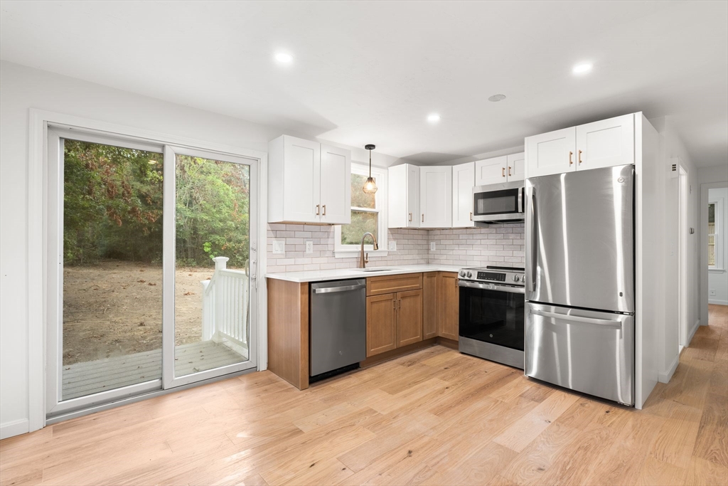 34 Saddleback Road Mashpee, MA 02649 - Photo 4 of 24 a kitchen with a refrigerator and a stove top oven