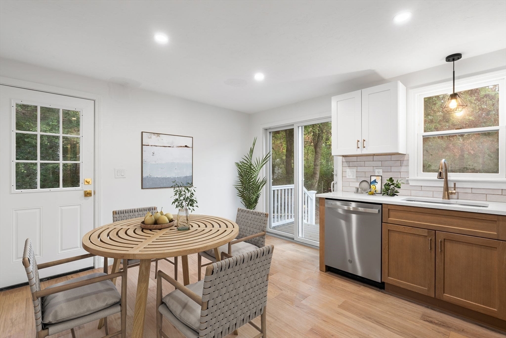 34 Saddleback Road Mashpee, MA 02649 - Photo 5 of 24 a kitchen with stainless steel appliances a dining table and chairs