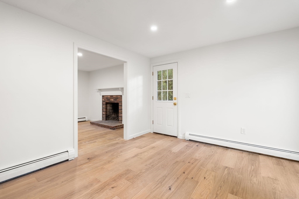 34 Saddleback Road Mashpee, MA 02649 - Photo 7 of 24 an empty room with wooden floor and a window
