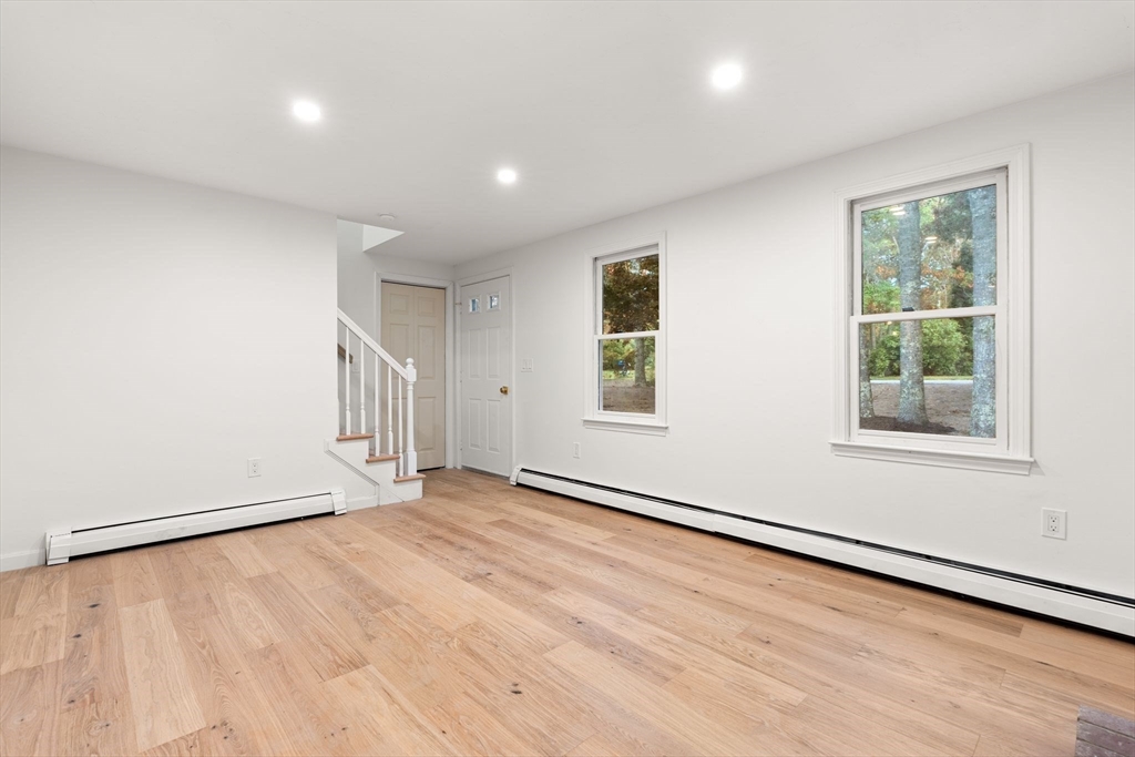 34 Saddleback Road Mashpee, MA 02649 - Photo 8 of 24 an empty room with wooden floor and windows